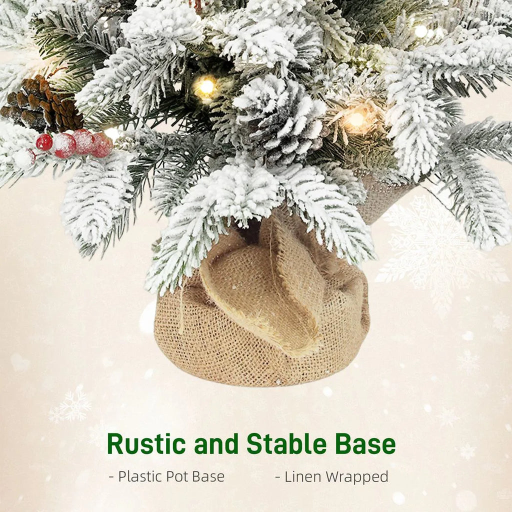 60 cm Prelit Small Christmas Tree with 35 LED Lights, Snow Flocked Tabletop Mini Xmas Tree with Pine Cones, Berry Clusters and Linen Cover Base, Battery Operated, Green